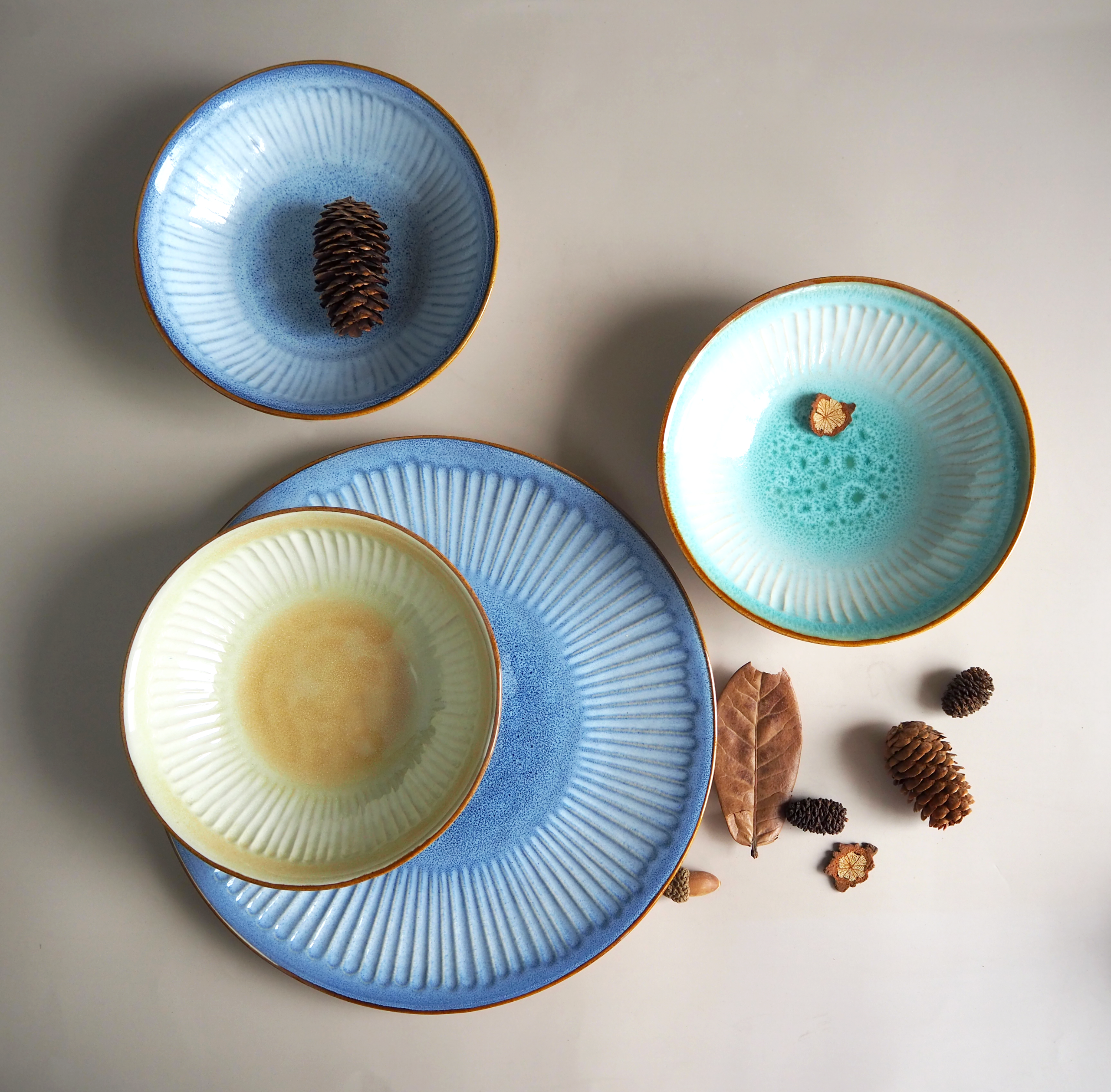 A collection of complex ceramic products including vases, plates, and mugs on a shelf