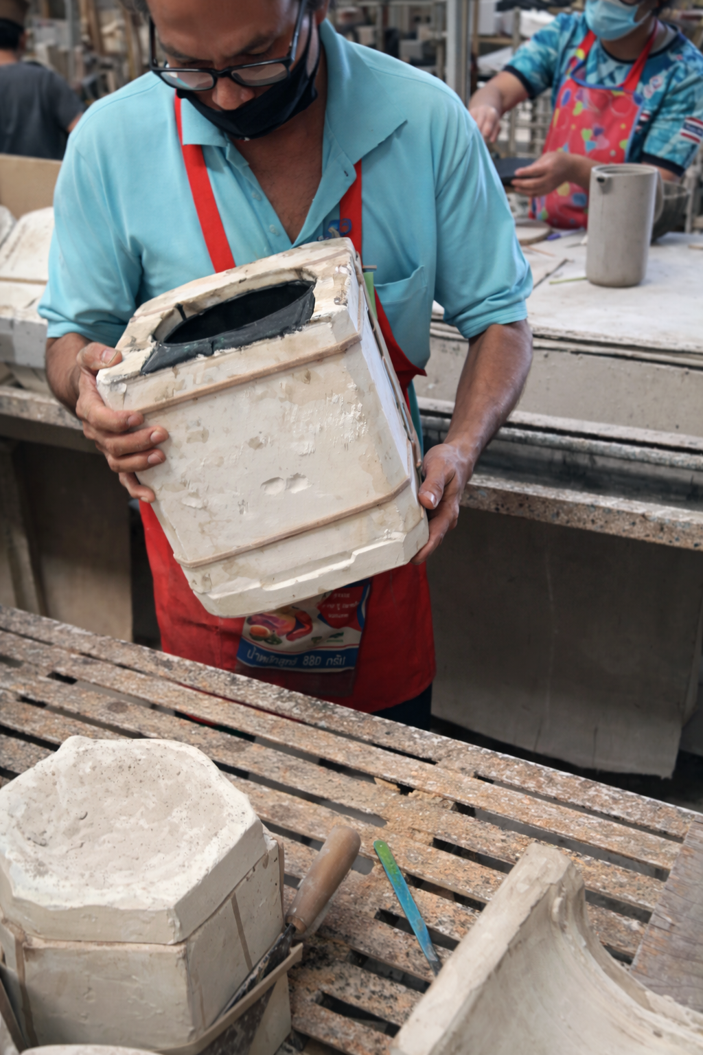 A large pile of raw clay material at a processing facility