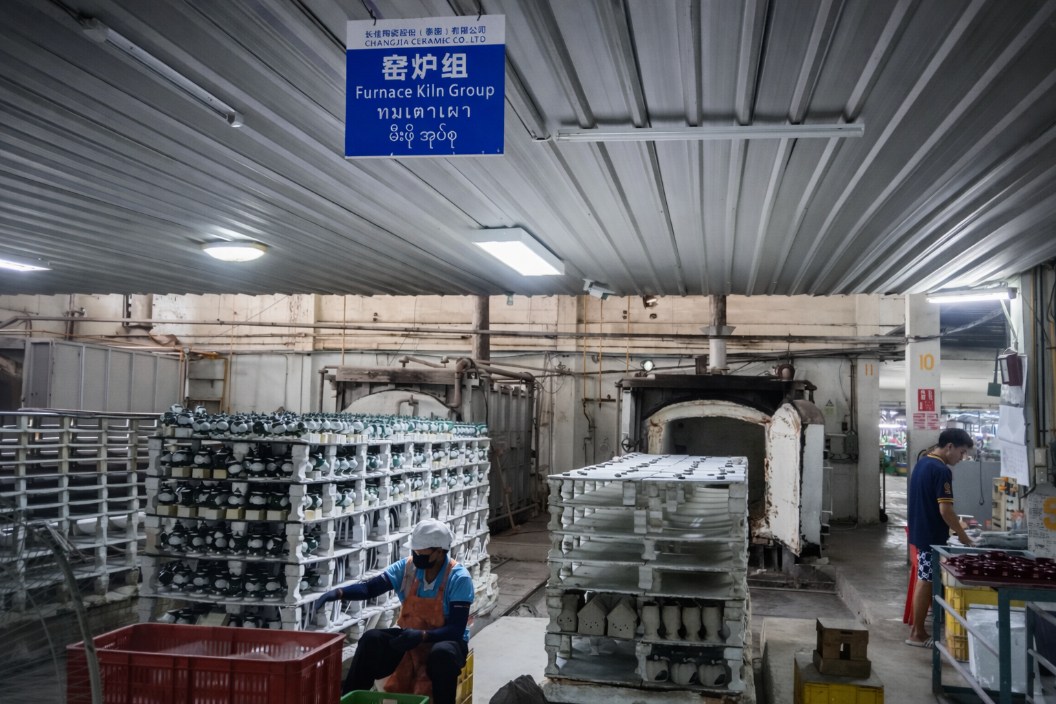 A quality control expert comparing a ceramic plate to a color chip